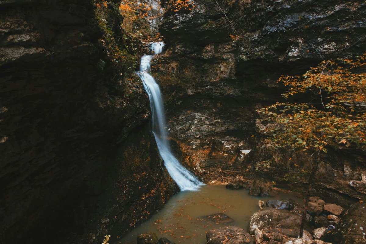 Tall limestone bluffs above the clear green Buffalo National River in the Arkansas Ozarks