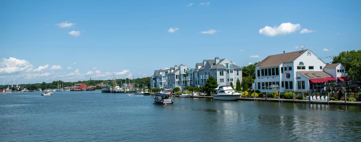 Historic tall ships docked along the Mystic River waterfront in Mystic, Connecticut