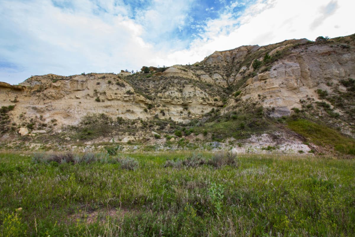 Layered badlands buttes and grassland in Theodore Roosevelt National Park, North Dakota