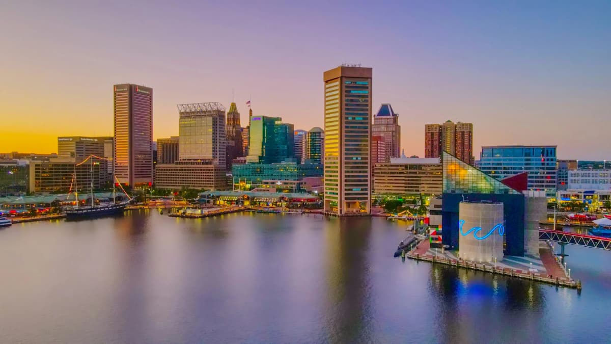 Baltimore Inner Harbor waterfront with the city skyline at dusk
