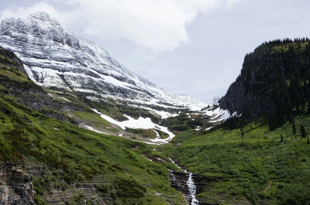 Going-to-the-Sun Road winding along a mountainside above a glacial valley in Glacier National Park, Montana