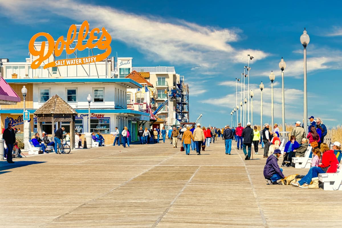 The Rehoboth Beach boardwalk running alongside the sand and the Atlantic Ocean in Delaware
