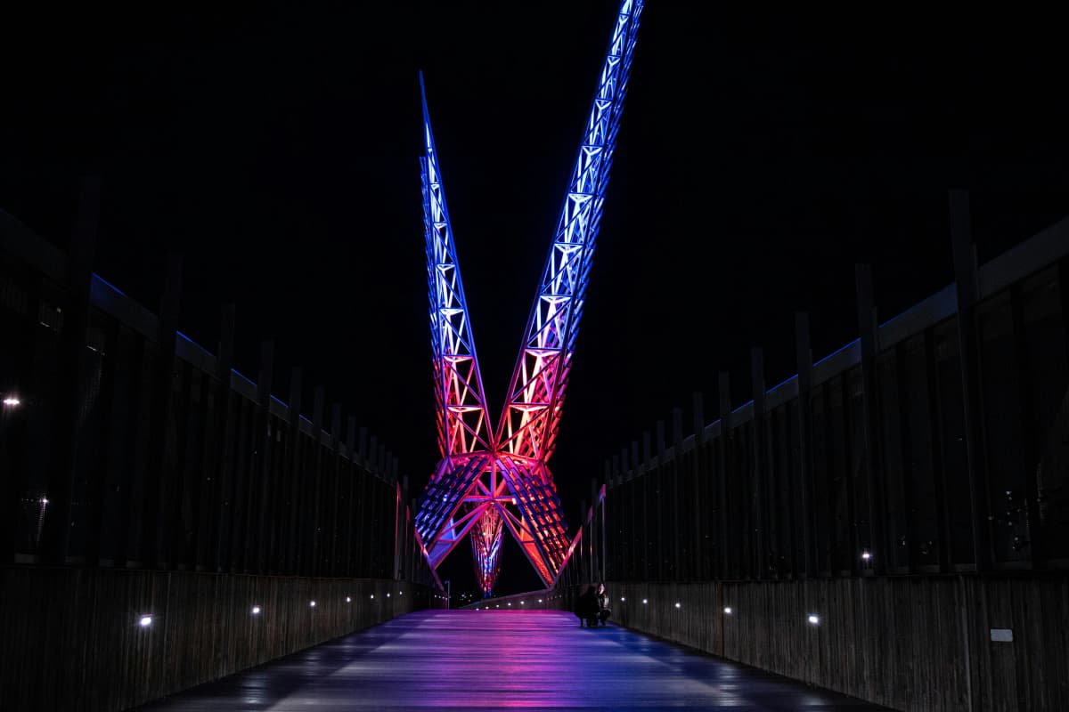 The Skydance Bridge in Oklahoma City lit against the downtown skyline at dusk