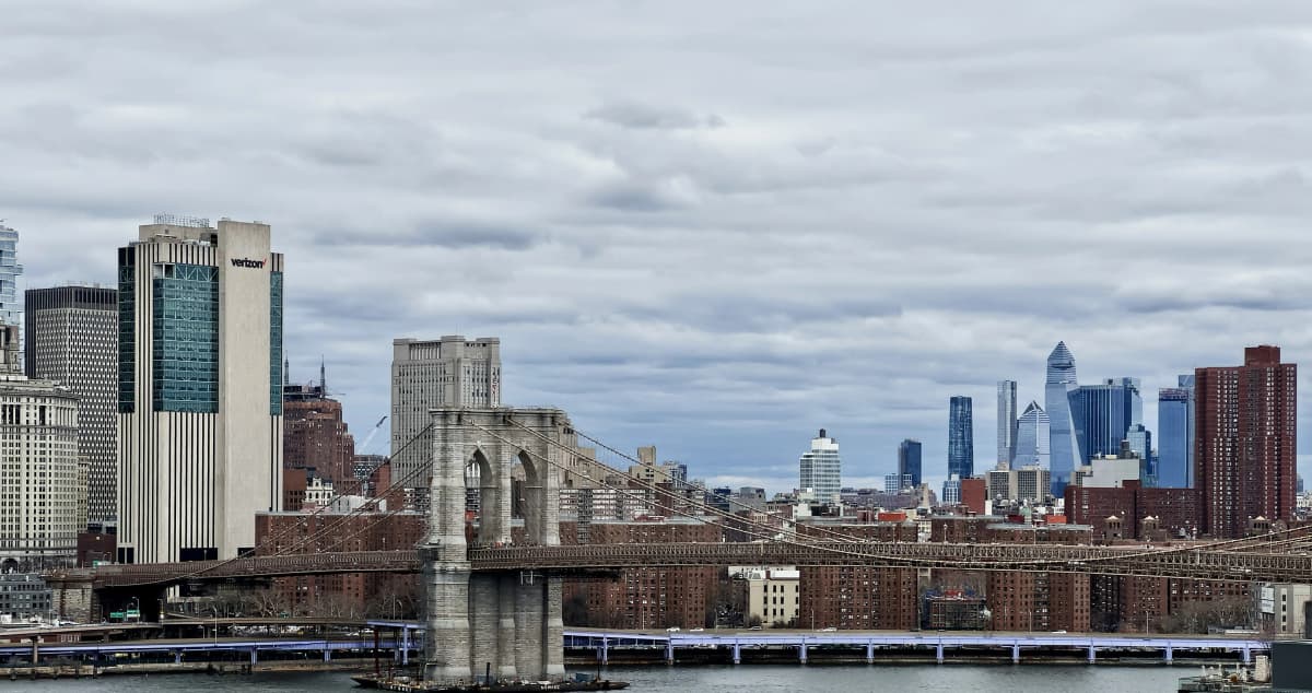 The Brooklyn Bridge stretching toward the Lower Manhattan skyline over the East River