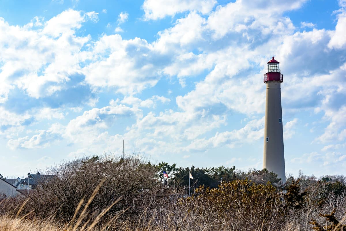 The Cape May Lighthouse standing above dunes and beach grass at the southern tip of New Jersey