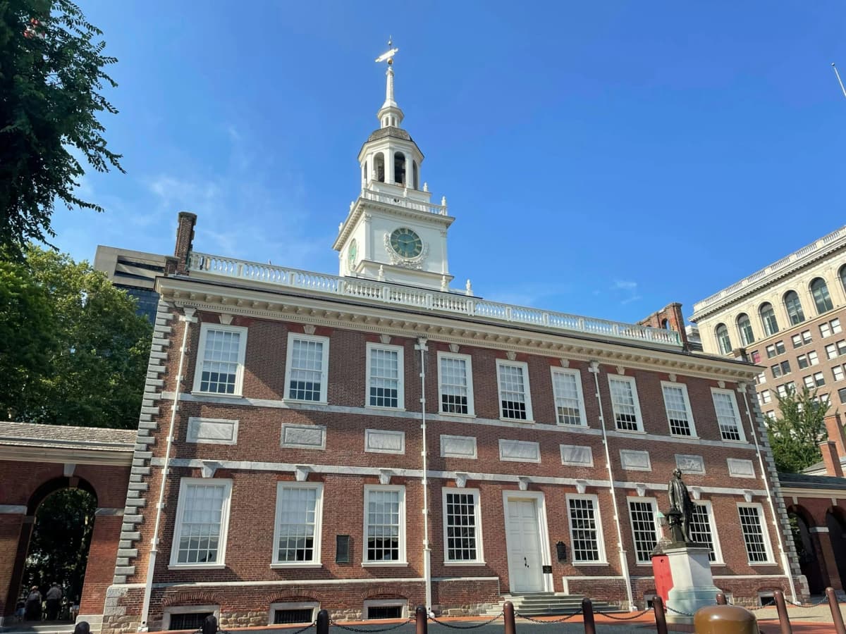 Independence Hall's red brick facade and clock tower in Philadelphia under a clear sky