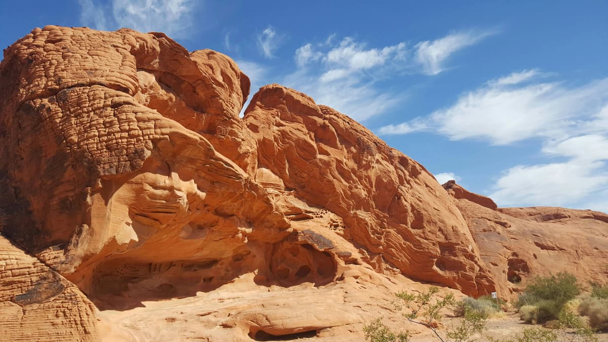 Red sandstone formations and a winding road through Valley of Fire State Park in the Nevada desert