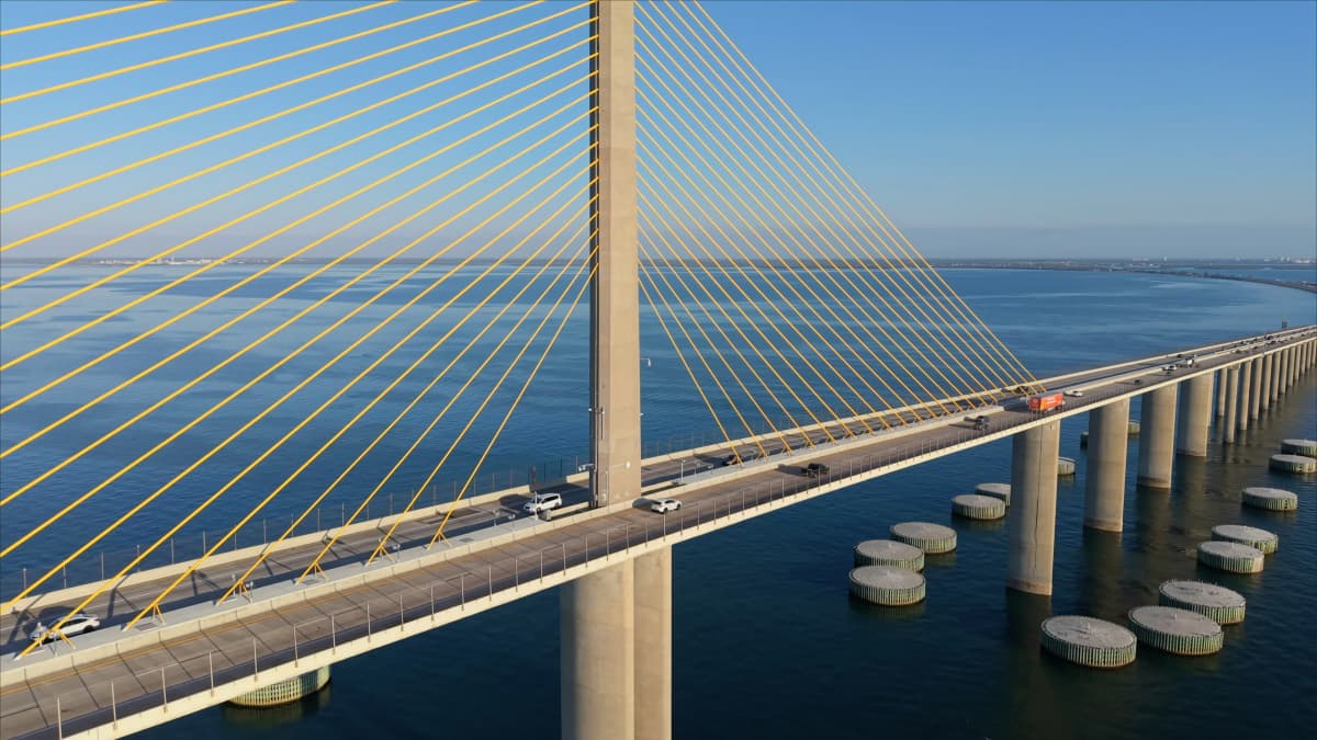 The yellow cable-stayed Sunshine Skyway Bridge spanning the blue water of Tampa Bay